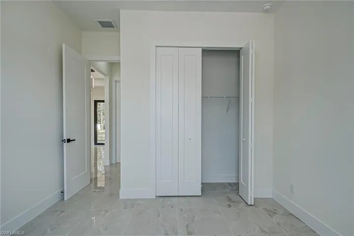 Unfurnished bedroom with baseboards and a closet