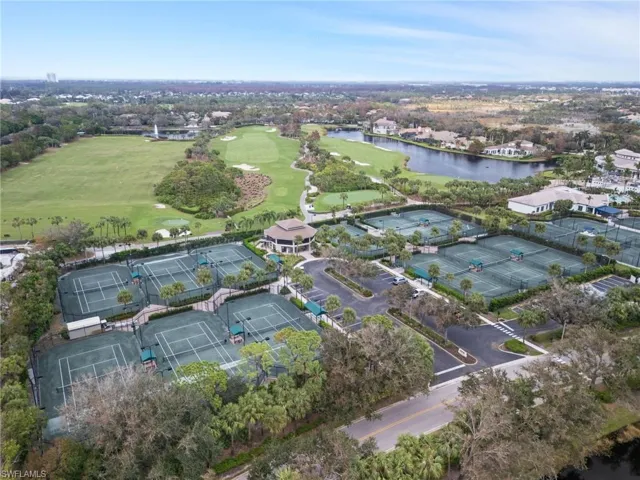 Aerial view of property's location with a large body of water and a golf course