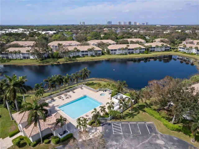 Aerial view of a pool area and a nearby body of water