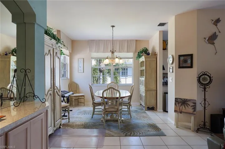 Dining area featuring light tile patterned floors and hanging lights