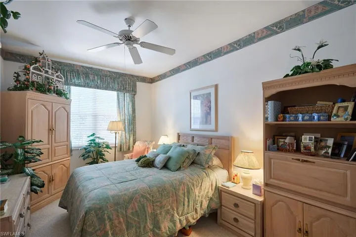 Bedroom with light colored carpet and ceiling fan