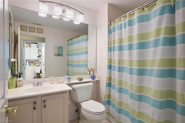 Bathroom with vanity and a shower with shower curtain