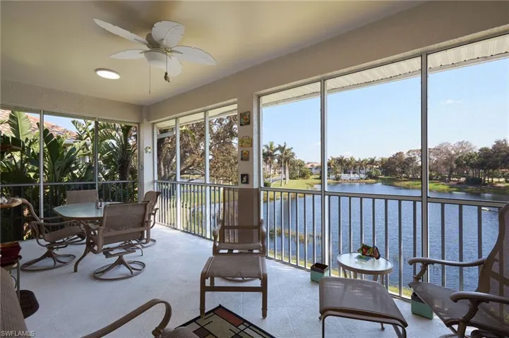 Sunroom featuring a water view and a textured wall