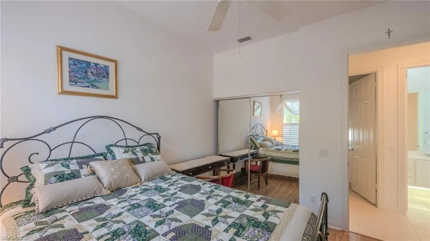 Bedroom featuring wood finished floors, a closet, and ceiling fan