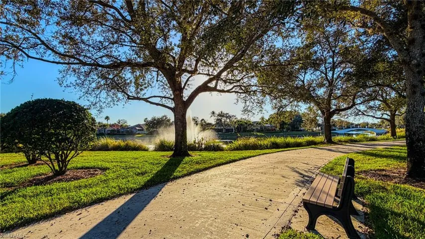 Surrounding community with a yard and a water view