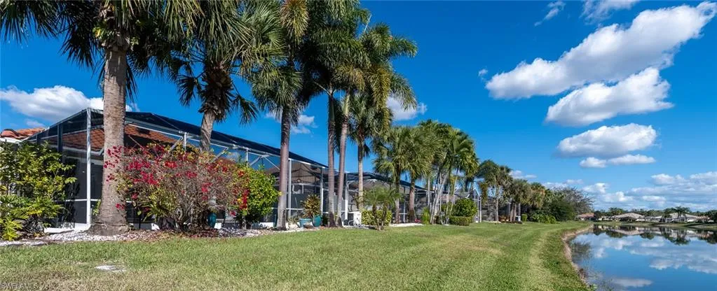 View of home's community with a lawn and a water view