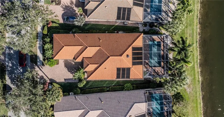 Aerial view of residential area featuring a large body of water
