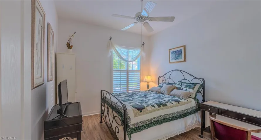 Bedroom with wood finished floors and a ceiling fan