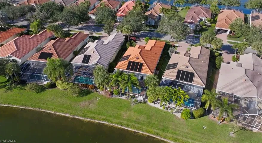 Aerial view of residential area featuring a large body of water