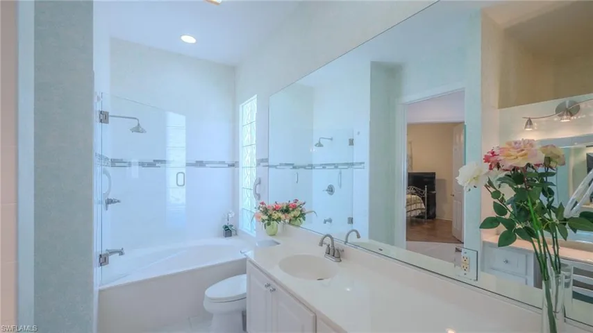 Ensuite bathroom with vanity, light tile patterned flooring, and bathing tub / shower combination