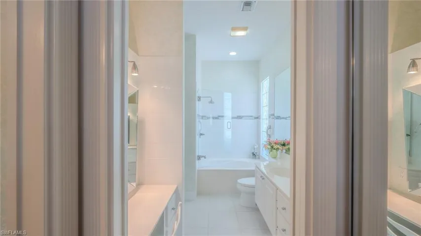 Full bathroom featuring vanity, light tile patterned floors, and tub / shower combination