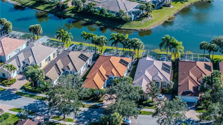 Aerial perspective of suburban area with a nearby body of water