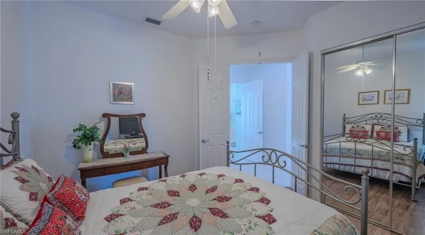 Bedroom featuring a ceiling fan, a closet, and wood finished floors
