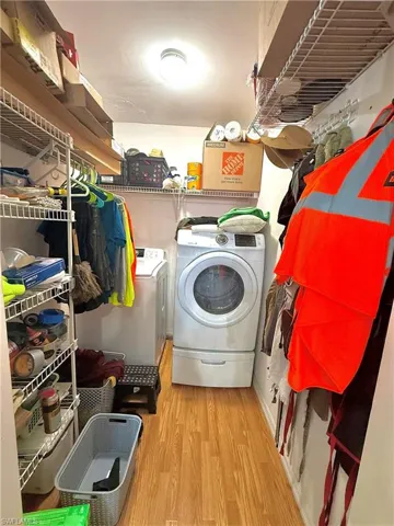 Laundry room featuring light wood-style flooring and washer and dryer