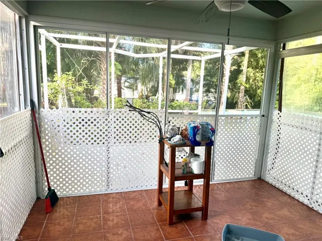 Unfurnished sunroom featuring healthy amount of natural light and ceiling fan