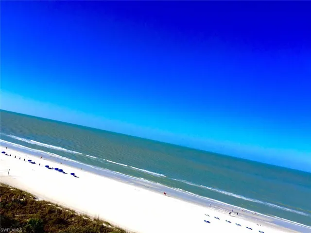 Direct beachfront access featuring white sand and coastal vegetation