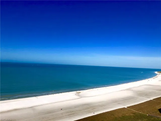 Oceanfront property featuring an expansive white sand beach and immediate shoreline access