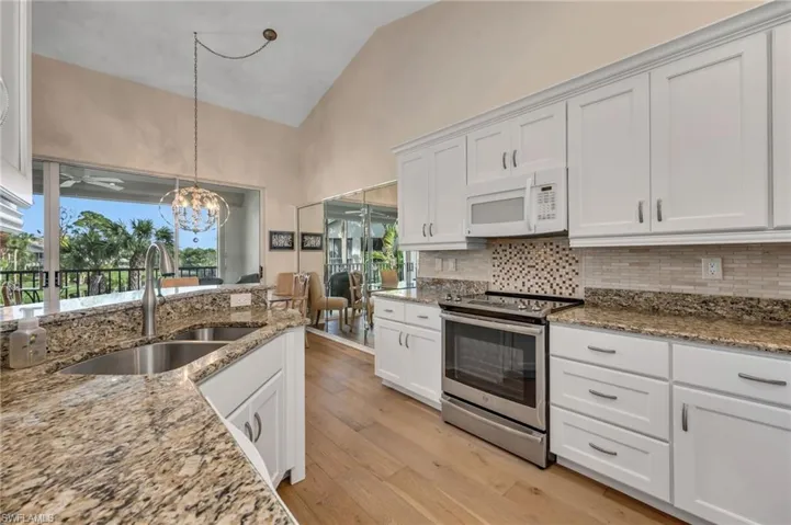 Light kitchen cabinetry with granite countertops.