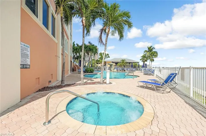 Community pool featuring a community hot tub and a patio