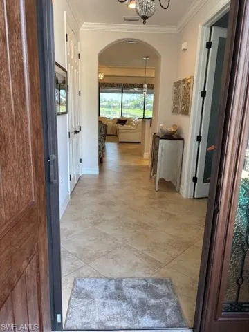 Hallway featuring crown molding