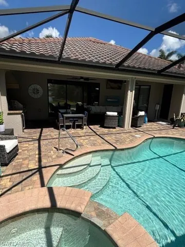 View of swimming pool featuring a lanai, a patio, and outdoor lounge area