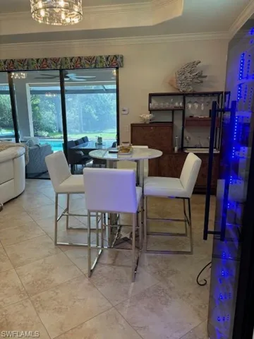 Dining space featuring crown molding and an inviting chandelier