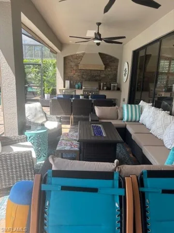 View of patio / terrace featuring an outdoor living space and ceiling fan