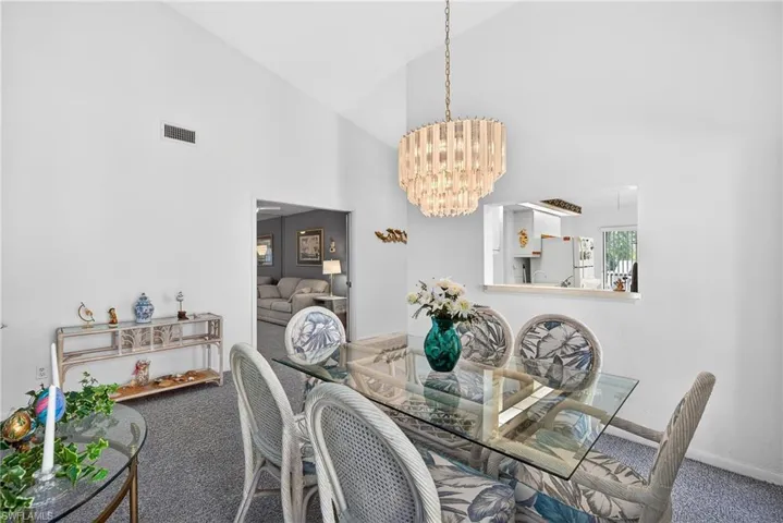Dining space featuring vaulted ceiling and hanging lights