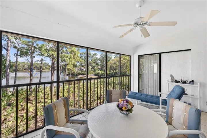 Lanai featuring outdoor dining space, ceiling fan, a water view, and lofted ceiling