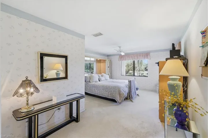 Bedroom featuring a ceiling fan and light carpet