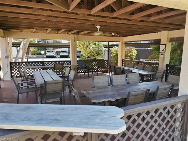 Wooden terrace with outdoor dining area and a patio area