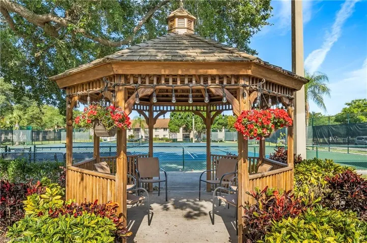 View of home's community with a gazebo, a tennis court, and a patio