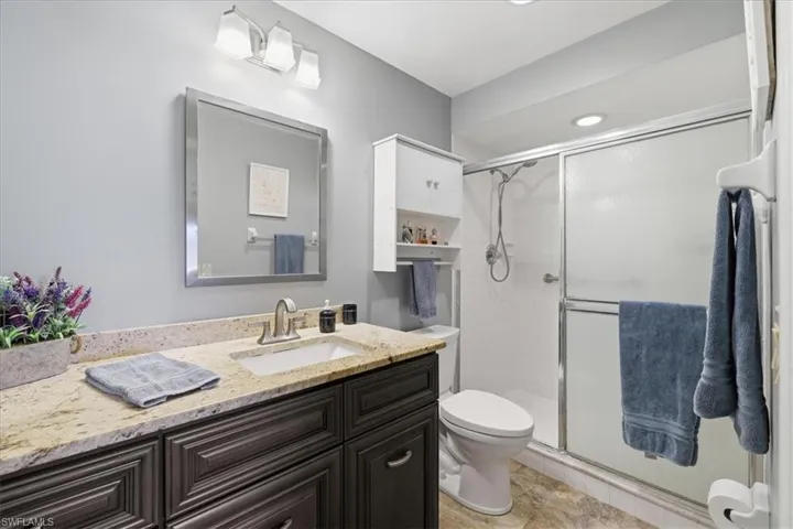 Full bath with a stall shower and vanity