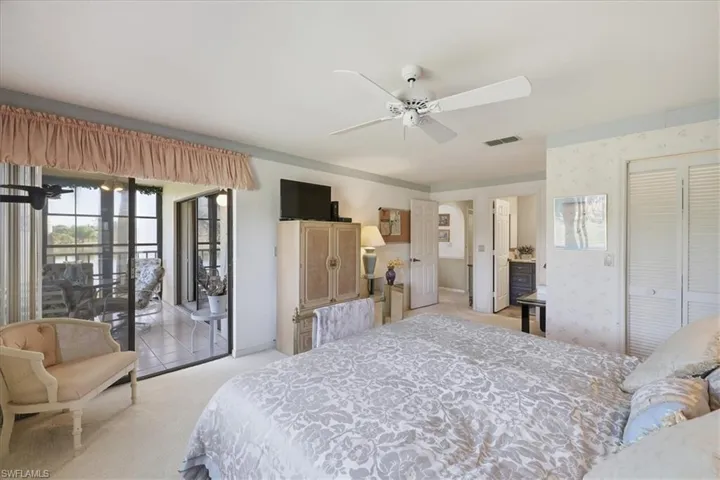 Bedroom with light colored carpet, access to exterior, a ceiling fan, and a closet