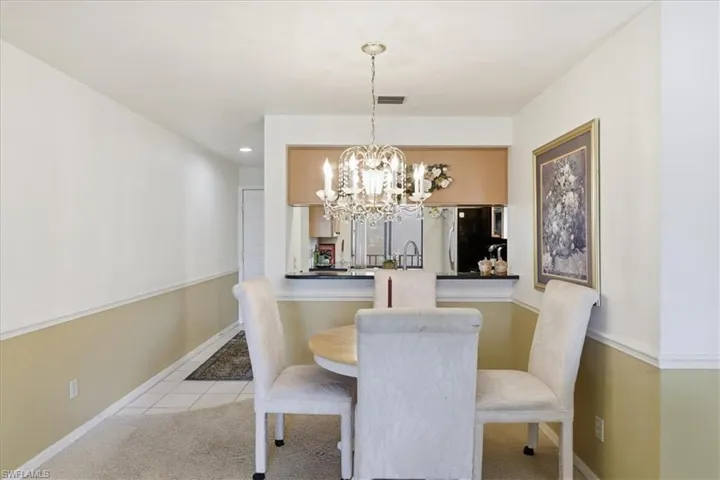 Dining space featuring hanging lights and light tile patterned floors