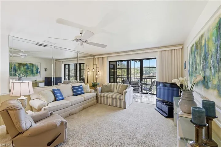 Living room featuring carpet floors and ceiling fan