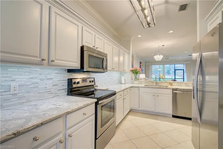 updated kitchen with stunning new quartz countertops and a beautiful backsplash