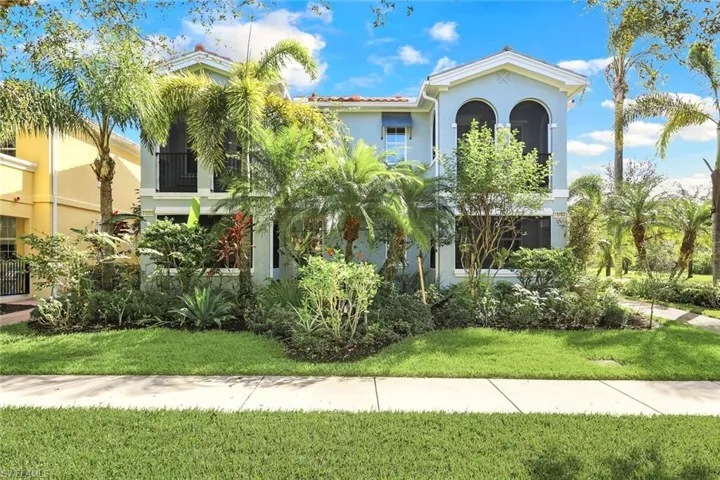 Welcome Home! A Beautiuful Mediterranean Inspired Home situated on a Landscaped Yard, Screened Porch & Upper Balcony