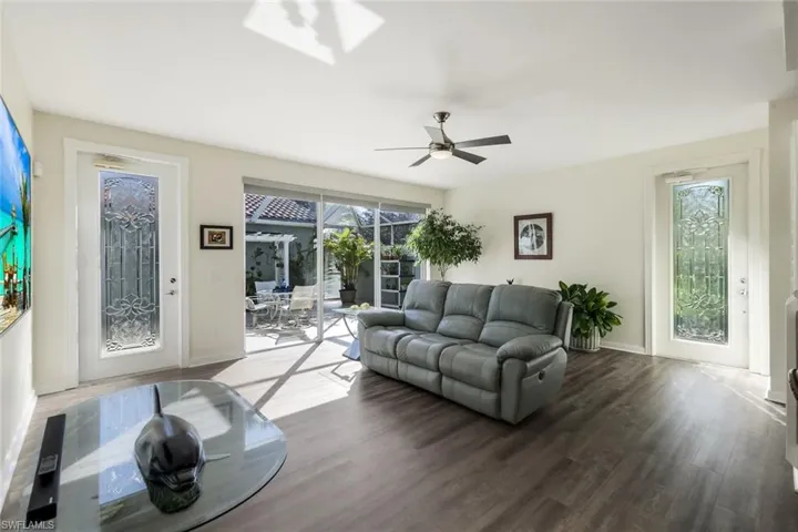 Great Room featuring Luxury Vinyl Plank Flooing, Decorative Glass door Inserts & Easy Access to the Lanai for Entertaining!