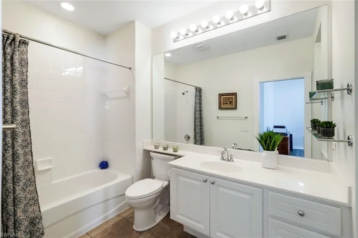 Full Bathroom with Cultured Marble Vanity & Walk in Closet
