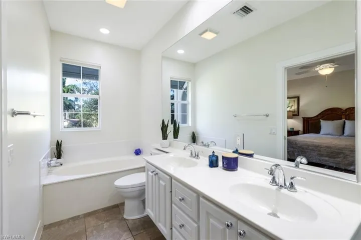 Bathroom Featuring Ceramic Flooring, Deep Soaking Tub, Double Sinks & Seperate Shower