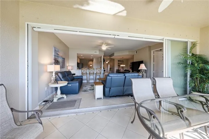 Open-concept living room with tile flooring and natural light