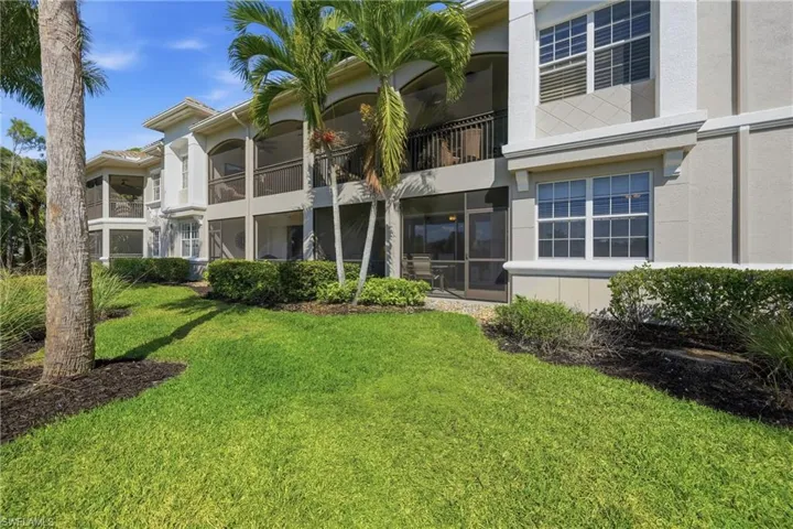 Exterior of Deer Crossing coach homes with tropical landscaping