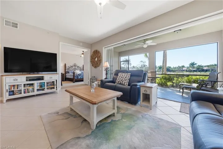 Open-concept living room with tile flooring and natural light