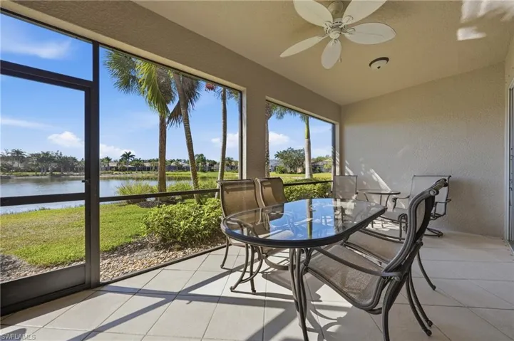 Southwest-facing screened lanai with panoramic lake and golf course views