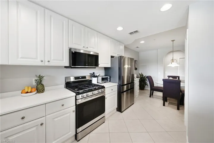 Kitchen featuring pantry storage and stainless appliances
