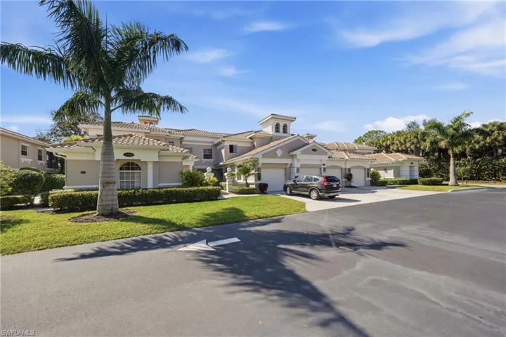 Exterior of Deer Crossing coach homes with tropical landscaping