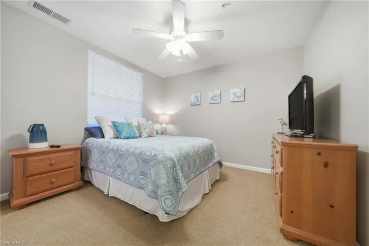 Guest bedroom with neutral finishes and natural light
