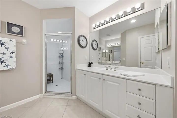 Primary bathroom with dual sinks and walk-in shower