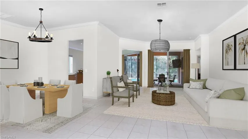Tiled living room with ornamental molding and a notable chandelier